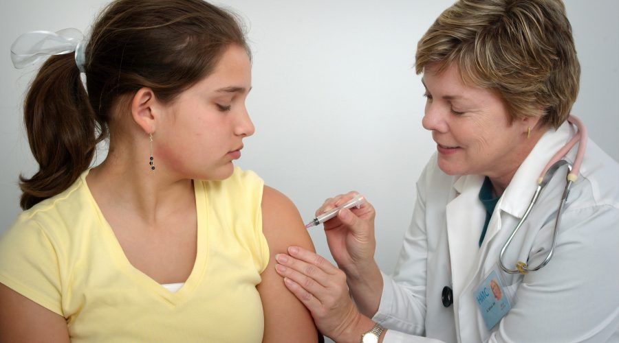 Girl being given a vaccine.